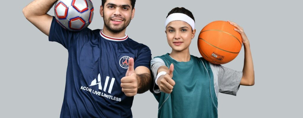 a man and a woman holding a basketball and posing for the camera